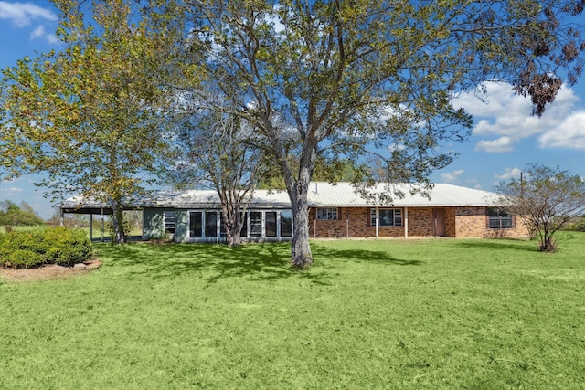 rear view of house featuring a lawn