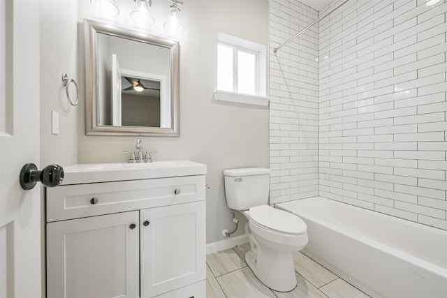 full bathroom featuring toilet, tiled shower / bath, and vanity