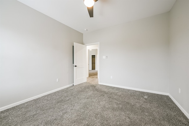 carpeted empty room featuring ceiling fan