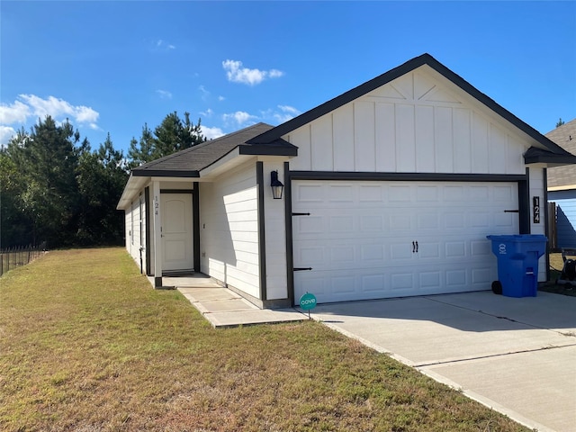 view of front facade featuring a garage, driveway, board and batten siding, and a front lawn