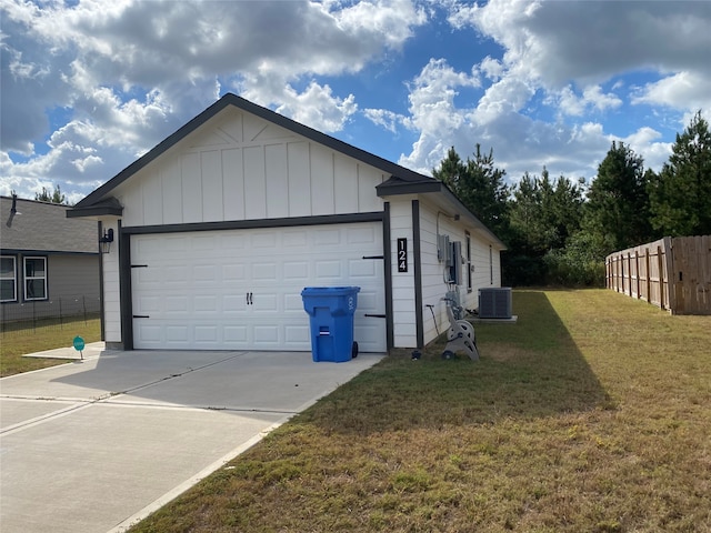 view of home's exterior featuring a lawn, a garage, and central AC unit