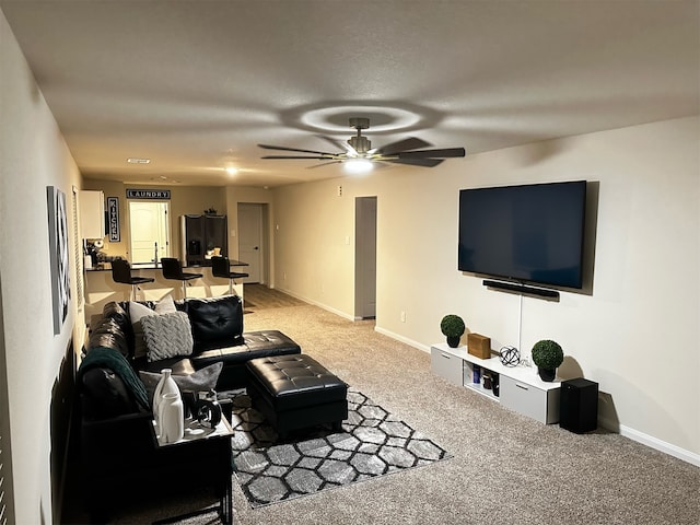 living room featuring carpet and ceiling fan