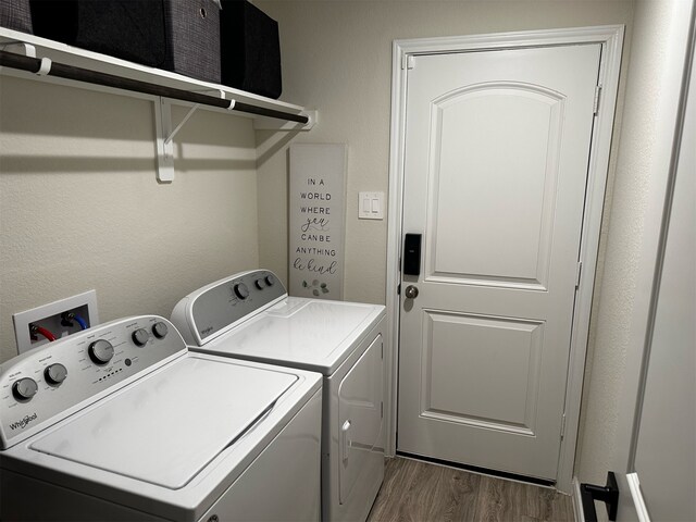 washroom with washing machine and dryer and dark hardwood / wood-style floors