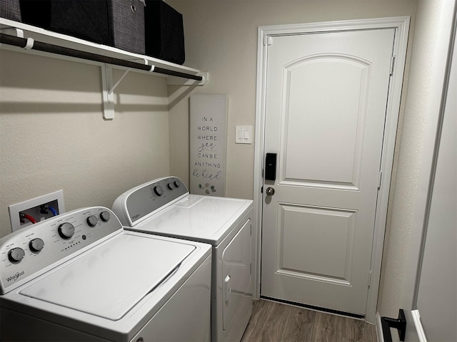 laundry room with dark wood-style floors, laundry area, and washer and clothes dryer