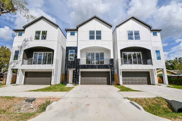 view of property with a balcony and a garage