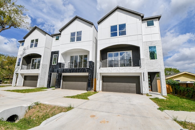 view of property featuring a balcony and a garage