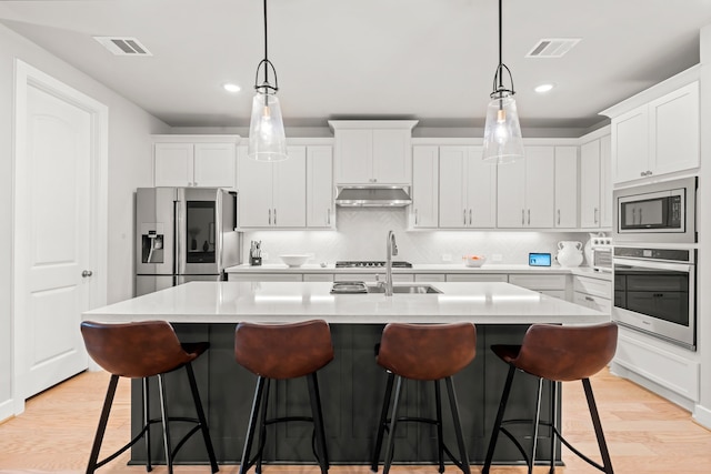 kitchen featuring light hardwood / wood-style floors, white cabinetry, and stainless steel appliances