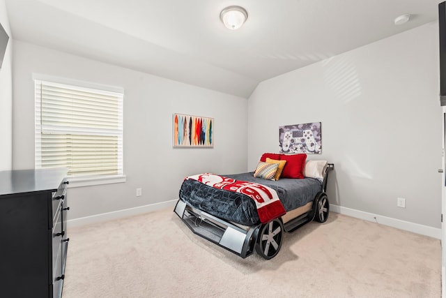 carpeted bedroom featuring vaulted ceiling