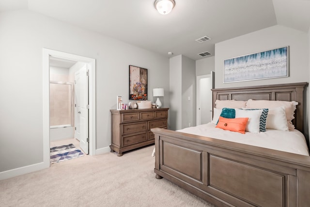 carpeted bedroom featuring connected bathroom and vaulted ceiling