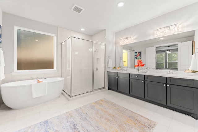 bathroom with vanity, ceiling fan, tile patterned floors, and plus walk in shower