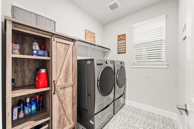 laundry room with washer and dryer and a barn door