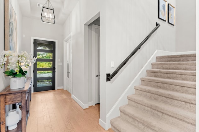 entrance foyer featuring a notable chandelier and light wood-type flooring