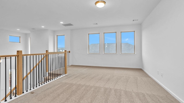 spare room featuring light colored carpet