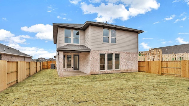 back of property featuring a lawn, a patio, and central air condition unit