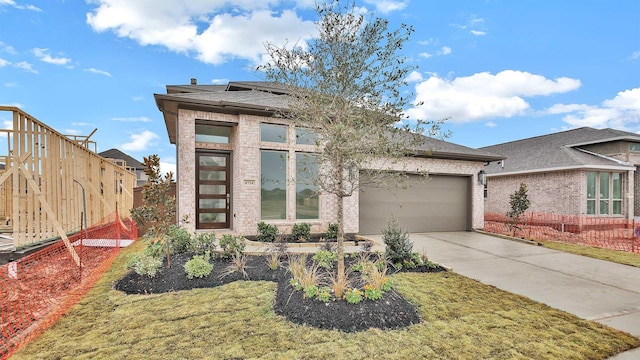 view of front facade with a garage and a front lawn