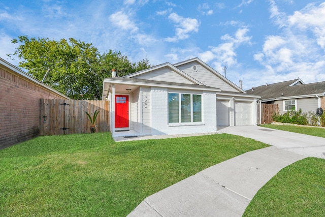 view of front of property featuring a front lawn and a garage