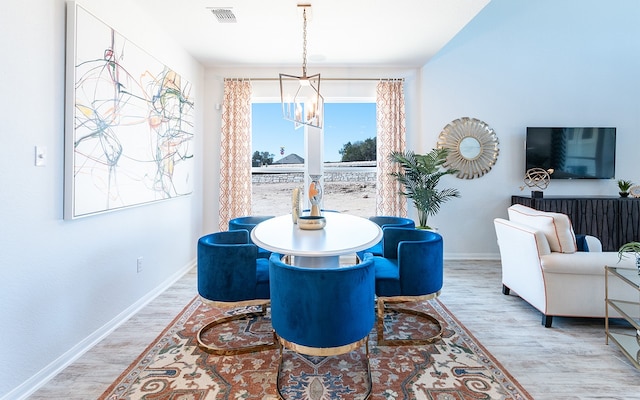 dining room featuring a chandelier and light wood-type flooring