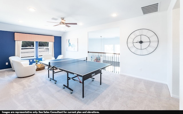 recreation room featuring light carpet and ceiling fan