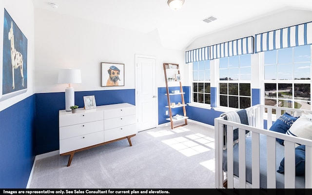 carpeted bedroom with lofted ceiling