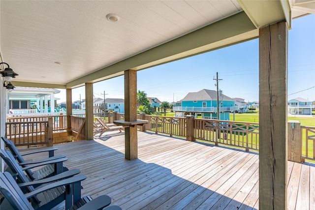 wooden terrace featuring a yard and ceiling fan