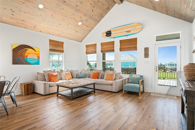 living room featuring light hardwood / wood-style floors, high vaulted ceiling, beam ceiling, and wood ceiling