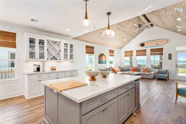 kitchen featuring light hardwood / wood-style floors, wooden ceiling, pendant lighting, and gray cabinetry