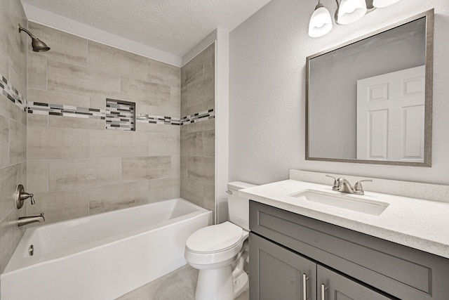 full bathroom featuring vanity, tiled shower / bath combo, a textured ceiling, and toilet