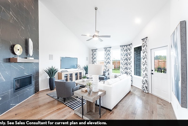 living room featuring wood-type flooring, high vaulted ceiling, and plenty of natural light