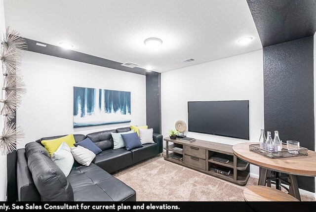 living room featuring light carpet and a textured ceiling