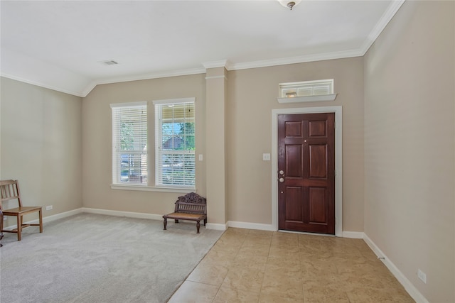 foyer with lofted ceiling, crown molding, and light carpet