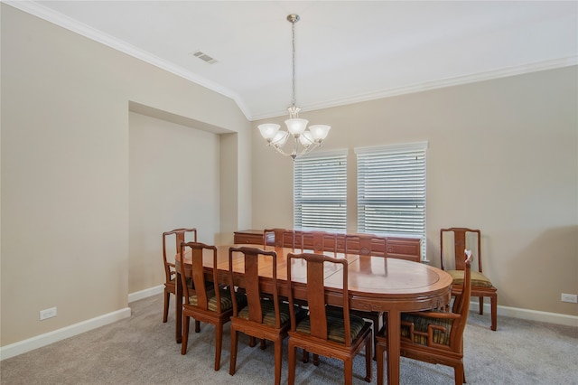 carpeted dining room with a notable chandelier and ornamental molding