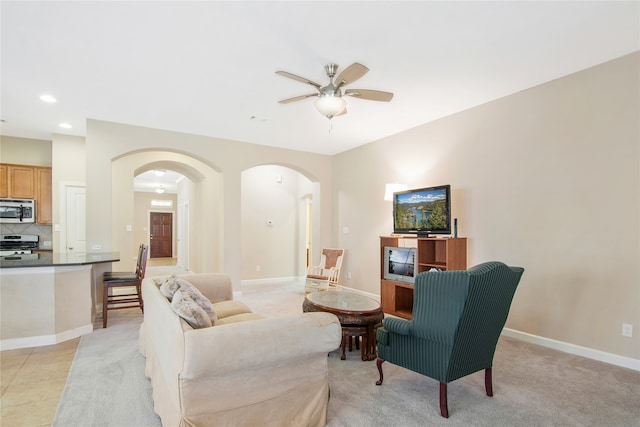 carpeted living room featuring ceiling fan