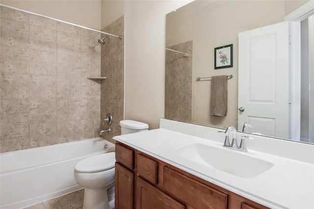 full bathroom featuring toilet, tiled shower / bath, vanity, and tile patterned floors