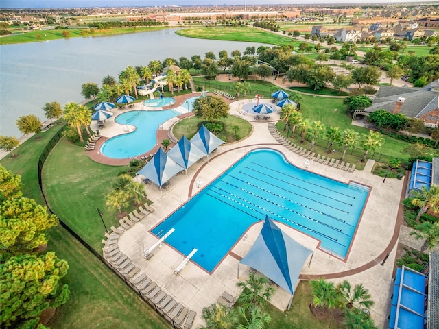 view of swimming pool with a water view and a patio area