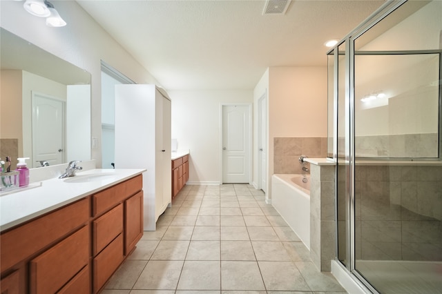 bathroom with vanity, plus walk in shower, and tile patterned flooring