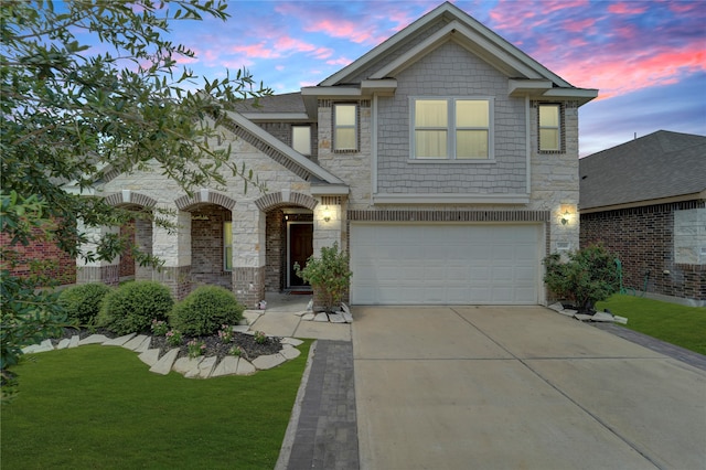 view of front facade with a garage and a lawn