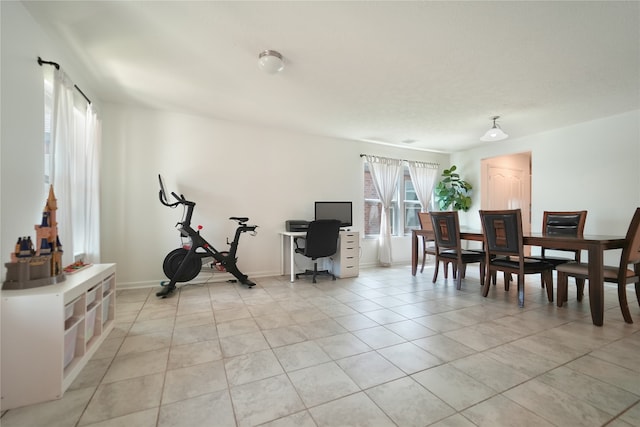 workout room featuring light tile patterned flooring