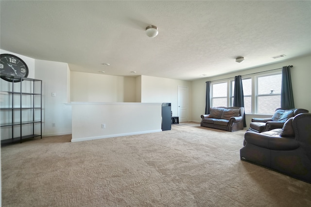 living room featuring light carpet and a textured ceiling