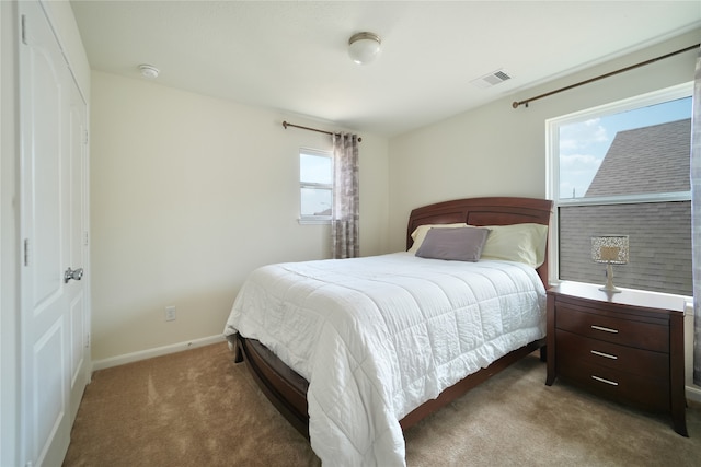 bedroom with multiple windows and carpet floors