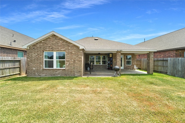 rear view of property featuring a patio and a lawn