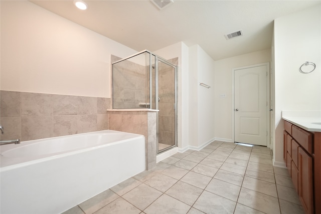 bathroom featuring vanity, tile patterned floors, and separate shower and tub