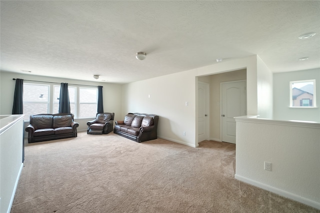 carpeted living room with a textured ceiling