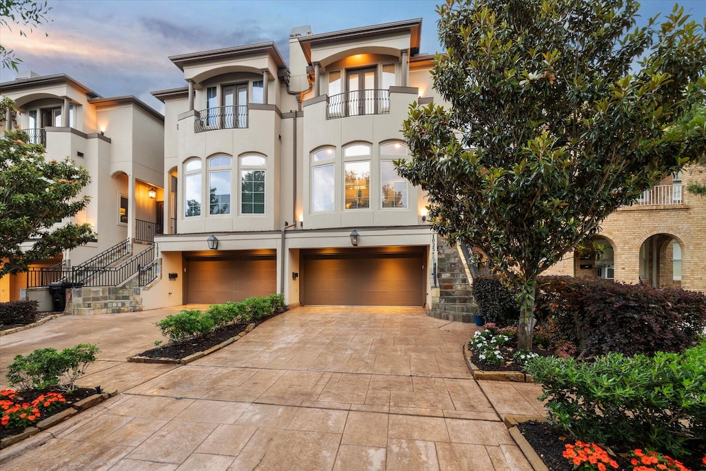 view of front of house with a garage and a balcony