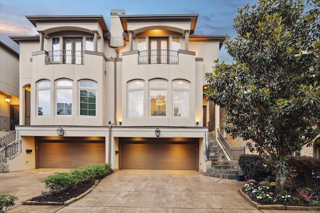 view of front of house with a garage and a balcony