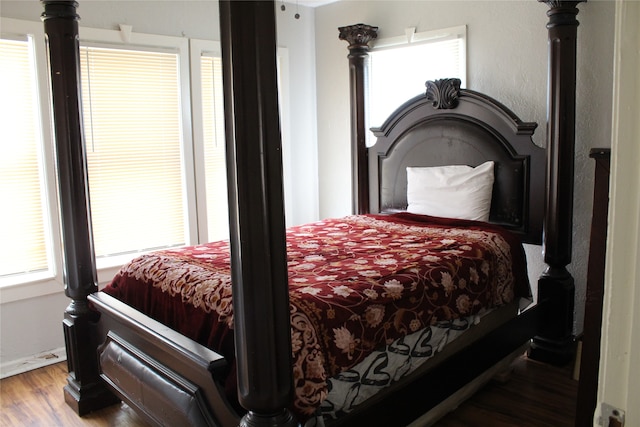 bedroom featuring hardwood / wood-style floors and multiple windows