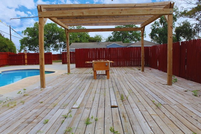 wooden deck featuring a pergola and a fenced in pool