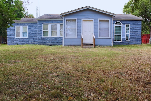 ranch-style home with a front lawn