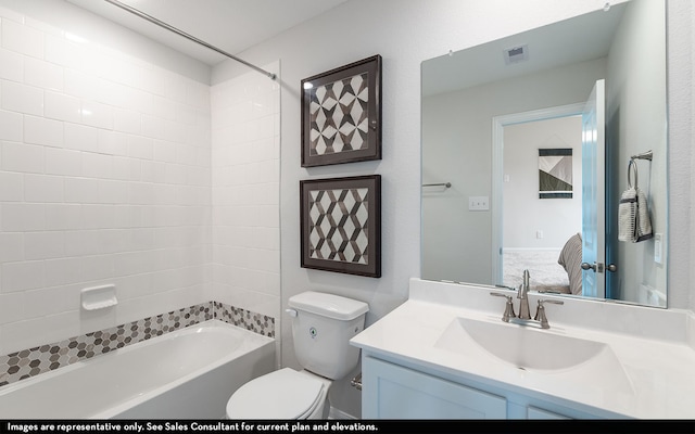 full bathroom with toilet, tiled shower / bath combo, and vanity