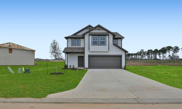 view of front of house featuring a front yard and a garage