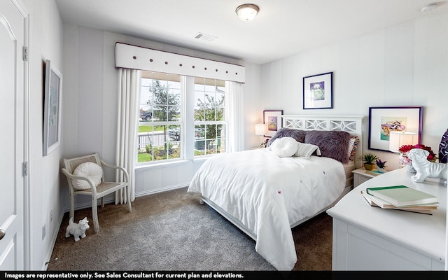 bedroom with dark colored carpet